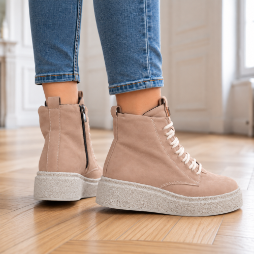 Beżowe sneakersy na drewnianej podłodze (2).png